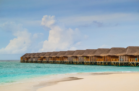 Overwater Bungalows on a Tropical Beach - Travel Backgroundの写真素材