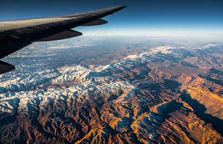 Aerial View from an Airplane. Flying above Beautiful Land at Sunrise.の写真素材