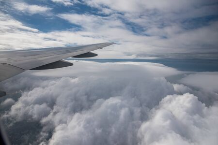 Aerial View from an Airplane. Flying above Clouds at Sunriseの写真素材