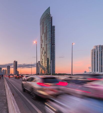 Skyscrapers and Traffic on Taksin Bridge in Bangkok, Thailand at Sunsetの写真素材