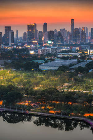 Bangkok, Thailand. Cityscape with Public Park and Skyscrapers at Twilight.の写真素材
