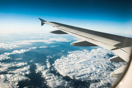 view from an airplane above the cloudsの写真素材