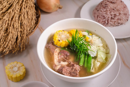 Savory Filipino food bulalo dish served in a bowl with rice and on the sideの写真素材
