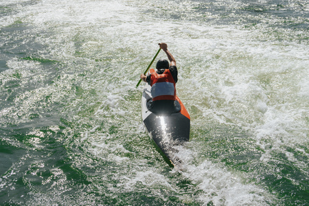 Kayak pilot fighting against the streamの写真素材
