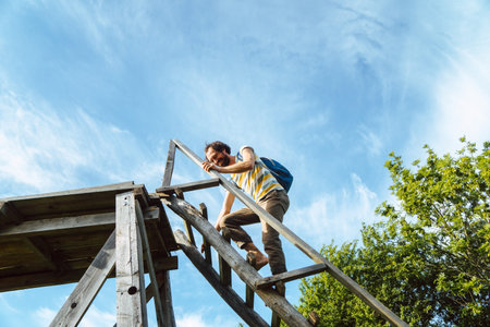 young caucasian man climbing a high standの写真素材
