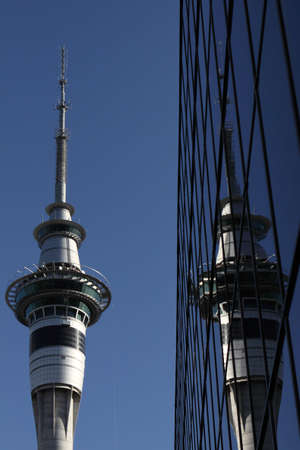 Skytower building reflecting in glass sided corporate building Auckland New Zealandの写真素材