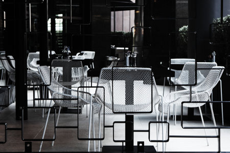 Black and white chairs and tables in a cafeの写真素材