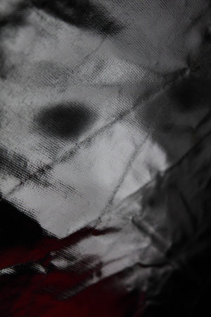 Scary face reflected in shiny surfaceの写真素材