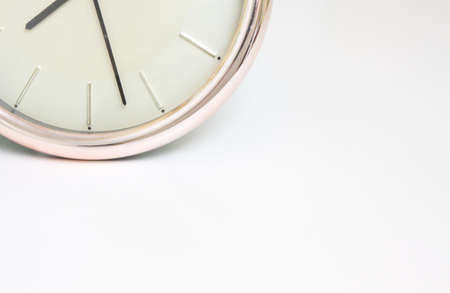 Clock showing the time, space for text, white backgroundの写真素材