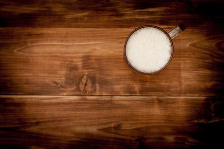 A glass of beer on the background of the wooden planks.の写真素材