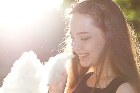 Portrait of a young girl with cotton candyの写真素材
