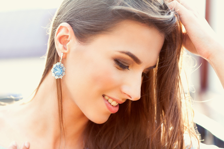 Portrait of a beautiful woman in sunny weather. In the youth style, beautiful hair and make-up.の写真素材