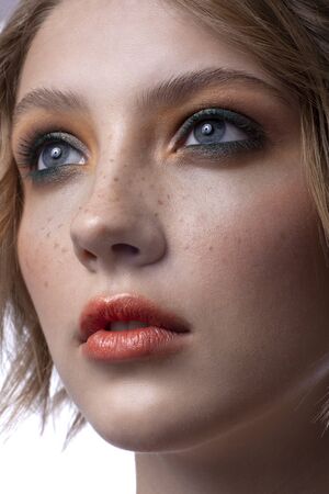 Portrait of a beautiful teenager girl. With wonderful makeup and hairstyle on a white background.の写真素材