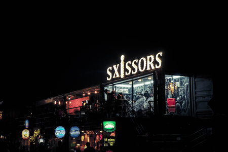 Barbershop,surrounding by pub, in the night market . This photo was taken on 17 November 2015 at Ratchada Night Market at Bangkok, Thailand.のeditorial素材