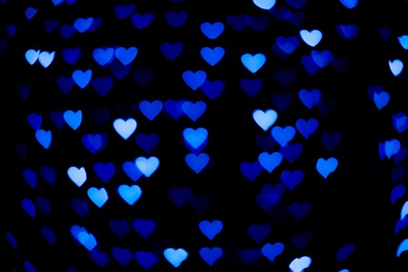 Blue heart bokeh in the dark.の写真素材