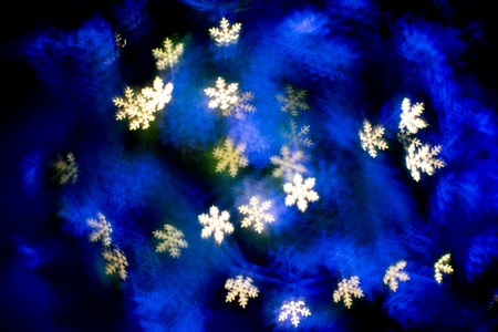 Yellow and blue snowflake bokehs at night.の写真素材