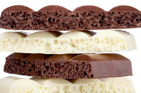 Stack of brown and white porous chocolate isolated on the white backgroundの写真素材