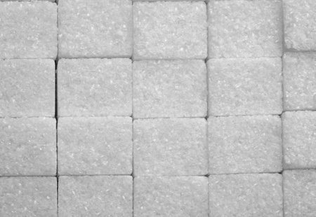 White sugar cubes arranged at the backgroundの写真素材