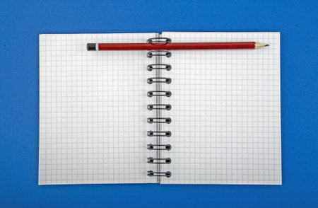 open blank of spiral notebook with pen isolated background.