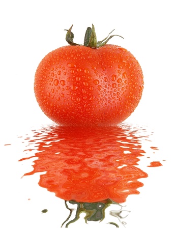 Fresh tomato with drops and refletion on water smooth surface の写真素材