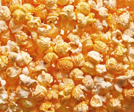 Pile of fresh popcorn filling the frame against bright lightの写真素材