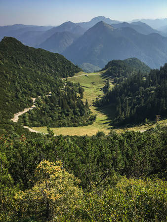 Panoramic view over the German bavarian Alps - Hiking on the ridge between two tops. The perfect place for rest while hiking. Impressive place for outdoor sports or activities.の写真素材