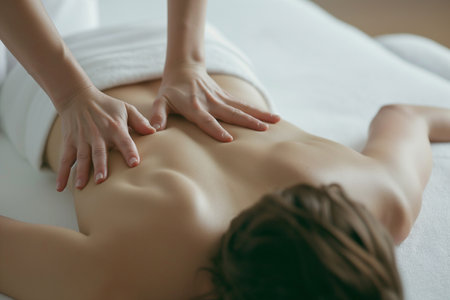 Close-up of a young woman receiving back massage in spa salonの素材