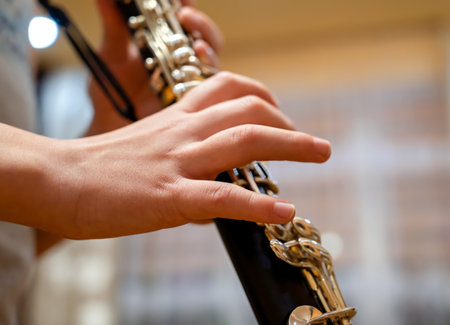 Close up of children's hands playing the clarinet in a music studioの写真素材