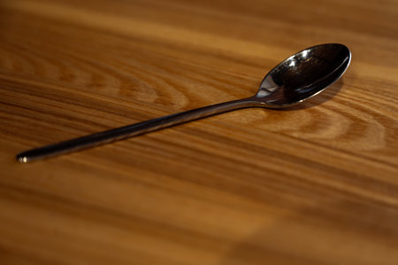teaspoon on a wooden table, in a cafeの写真素材