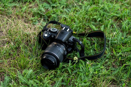 Camera on green grass with bokehの写真素材