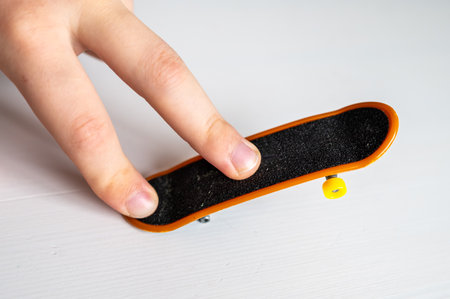 children's hands playing with a toy fingerboard, developing fine motor skills, selective focusの写真素材