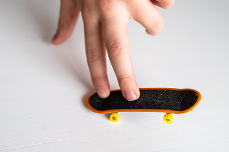 children's hands playing with a toy fingerboard, developing fine motor skills, selective focusの写真素材