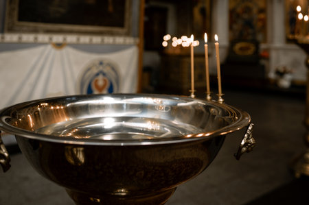 baptismal font with burning candlesの写真素材