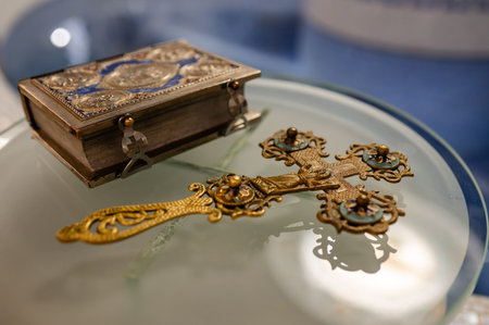 Close up of an old holy bible and cross on a plate.の写真素材