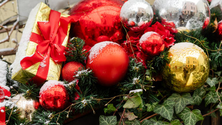 Bright red baubles and ribbon details on a Christmas tree creating a classic holiday lookの写真素材