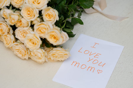 Children's handmade greeting card for Mother's Day with a fresh yellow rose bouquet, symbolizing...