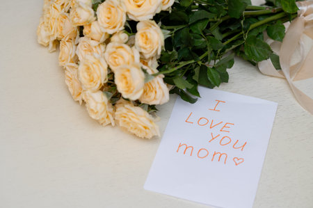 Children's handmade greeting card for Mother's Day with a fresh yellow rose bouquet, symbolizing...