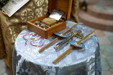 Close up of religious accessories for christening ceremony including wooden oil casket sea sponge...