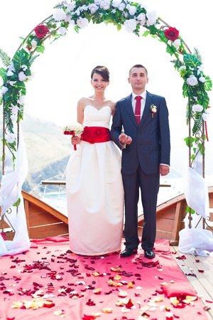 A young couple in love bride and groom with a bouquet, wedding day in summer. Enjoy a moment of happiness and love.の写真素材