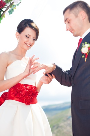 A young couple in love bride and groom with a bouquet, wedding day in summer. Enjoy a moment of happiness and love.の写真素材