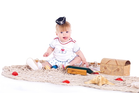 small beautiful child playing in studio on a white backgroundの写真素材