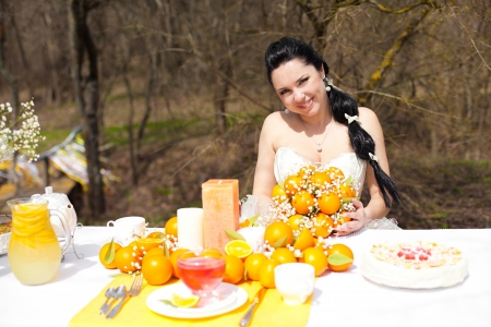 happy beautiful Bride at the banquet table in the countryside  Wedding Day, style in orangeの写真素材