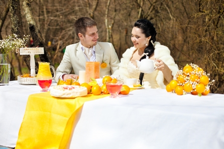 happy couple at the banquet table in the countryside  Wedding Day, style in orangeの写真素材