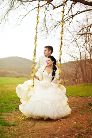 A beautiful pair of bride and groom posing in the park  Stylized Wedding in oranges の写真素材