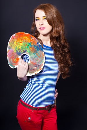 Young girl with a palette and brush  Studio shot の写真素材
