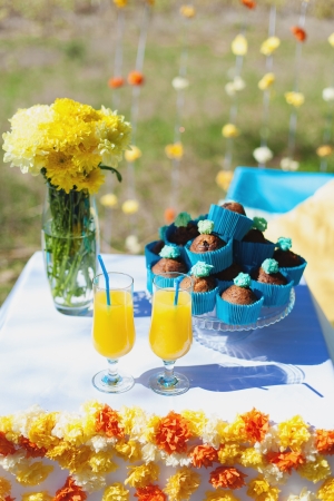 Wedding table decorated with flowers, cakes, cocktailsの写真素材