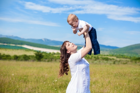 Family - happy mom and her son smiling at natureの写真素材