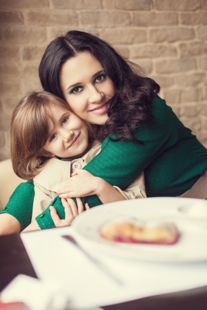 Mom and young daughter eating breakfastの写真素材