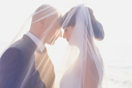 Happy newly married couple on their wedding day on the beach