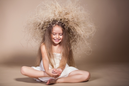 portrait of cute smiling girl with wreath on her headの写真素材